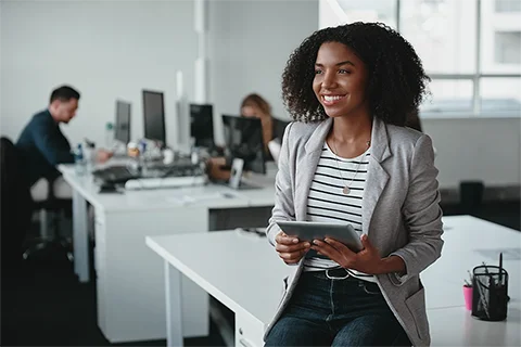 Woman in a UK asset finance office holding a tablet